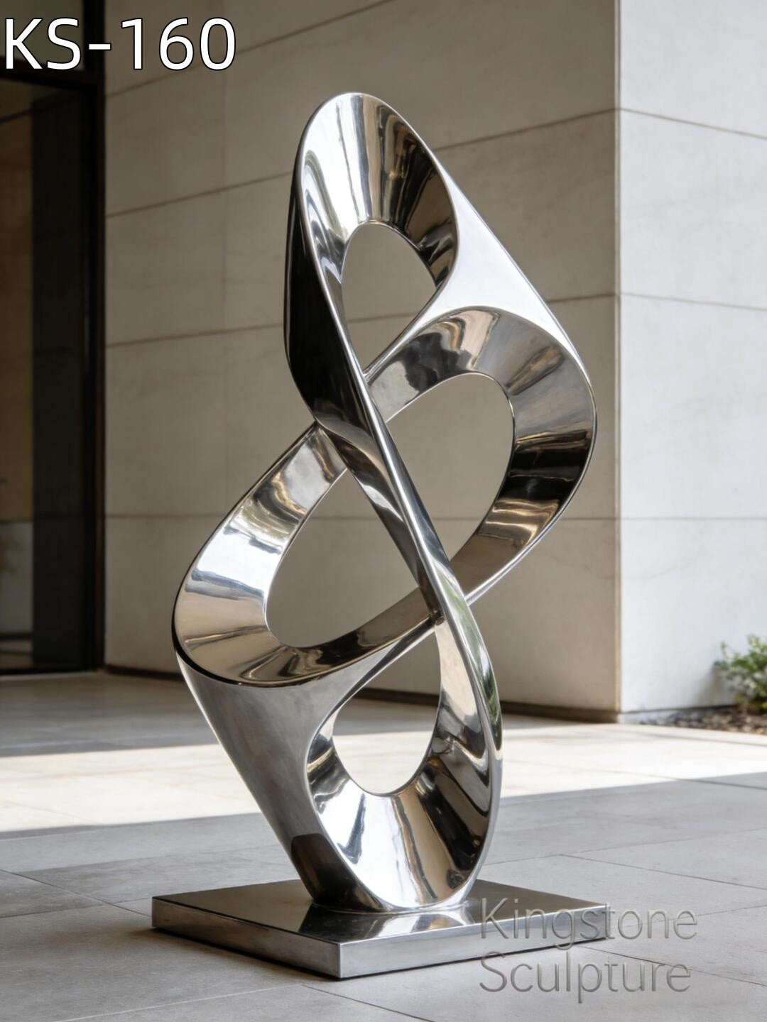 A soaring Kingstone KS-160 mirror polished stainless steel sculpture installed in a contemporary outdoor plaza reflecting the blue sky and modern surroundings.