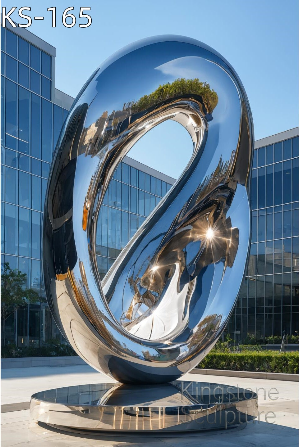 A monumental Kingstone KS-165 mirror polished stainless steel sculpture installed in a contemporary luxury garden near water, reflecting the sky.